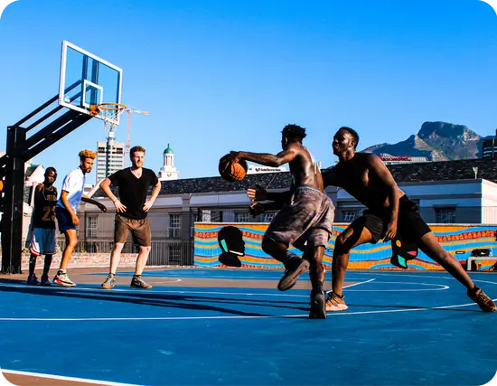 People playing basketball in a community.